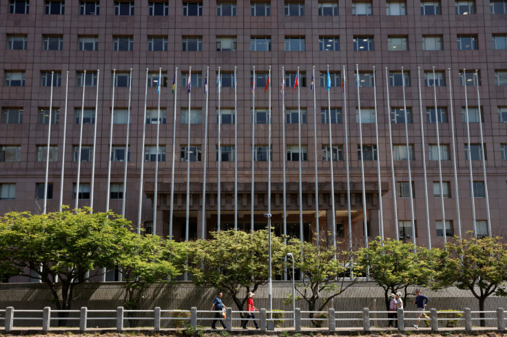 People walk past the Diplomatic Quarter, which houses the Honduras embassy among others, in Taipei