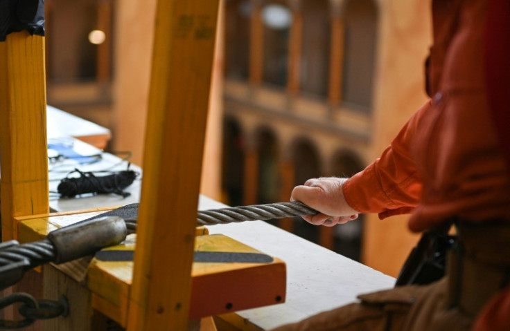 The high-wire act at the National Building museum will be 50 feet (15 meters) in the air