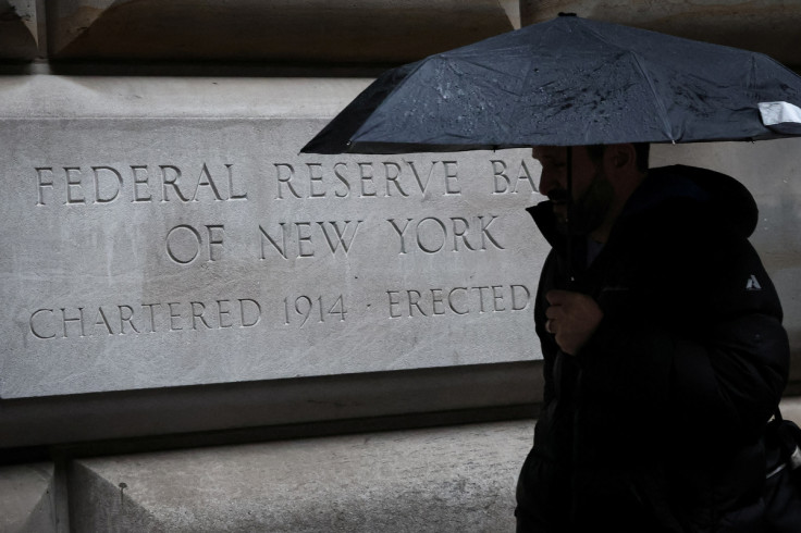 A man passes by The Federal Reserve Bank of New York in New York