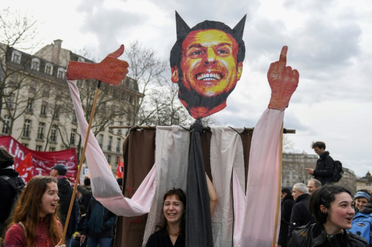 Protestors hold an effigy of French President Emmanuel Macron