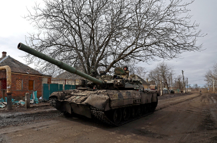 Ukrainian servicemen ride a tank on a road towards the frontline town of Bakhmut in Chasiv Yarr