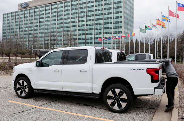 A model of the all-new Ford F-150 Lightning electric pickup is parked in front of the Ford Motor Company World Headquarters in Dearborn