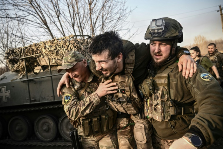 A wounded Ukrainian serviceman is lifted away from the front line near Bakhmut