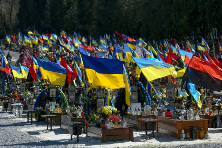 A sea of blue-and-yellow Ukrainian flags and red-and-black nationalist banners mark the graves of the fallen soldiers at the Lviv cemetery