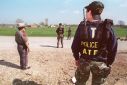 Agents from the Bureau of Alcohol, Tobacco and Firearms (ATF) and local Texan authorities are shown in March 1993 near the Branch Davidian compound in Waco, Texas