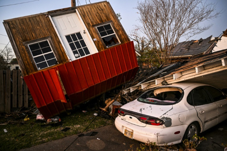 The remains of crushed house and cars are seen in Rolling Fork