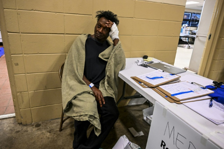 An injured man sits inside a makeshift clinic and relief center in Rolling Fork, Mississippi