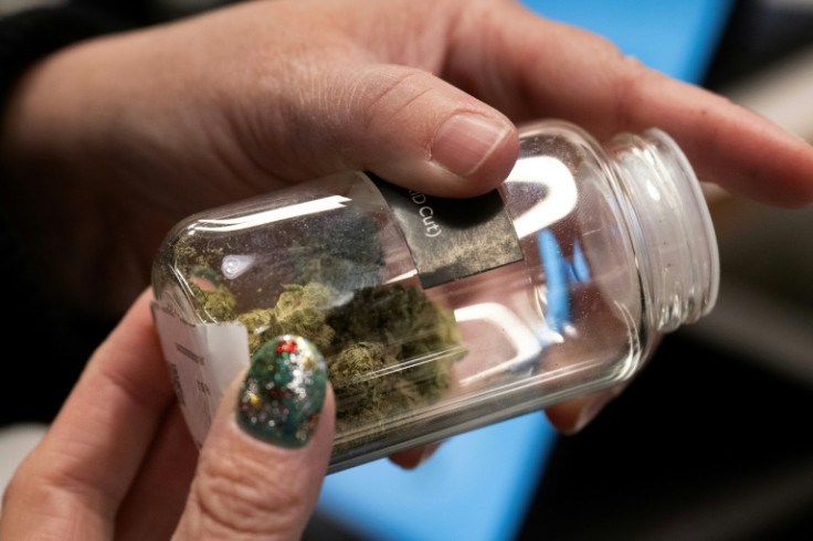 A customer looks at marijuana buds at the Proper Cannabis dispensary in Kansas City, Missouri