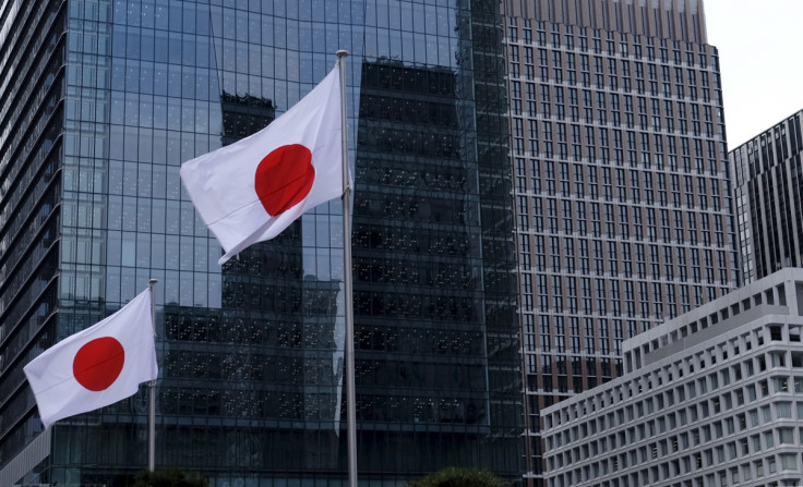 Japanese national flags flutter in front of buildings at Tokyo's business district