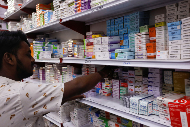 Shopkeeper arranges medicine packs in a medical supply store in Karachi