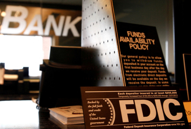 Signs explaining Federal Deposit Insurance Corporation (FDIC) and other banking policies are shown on the counter of a bank in Westminster