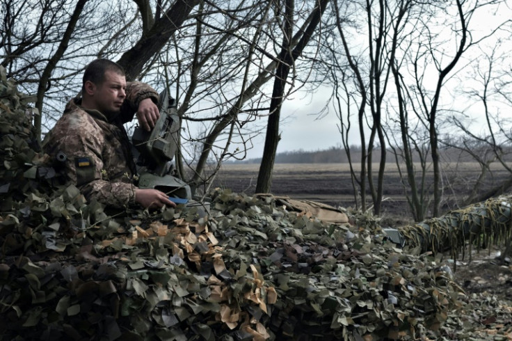 A Ukrainian serviceman sits on a T-72 tank on the front line near Bakhmut on March 26, 2023