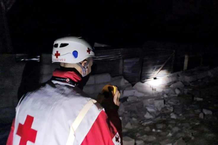 Dozens of rescuers and civilians worked to clear debris by hand in the dead of night with only flashlights for light to find survivors of a landslide in Ecuador