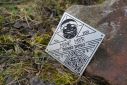 A metal plaque with a QR code clue to solving the troll mystery