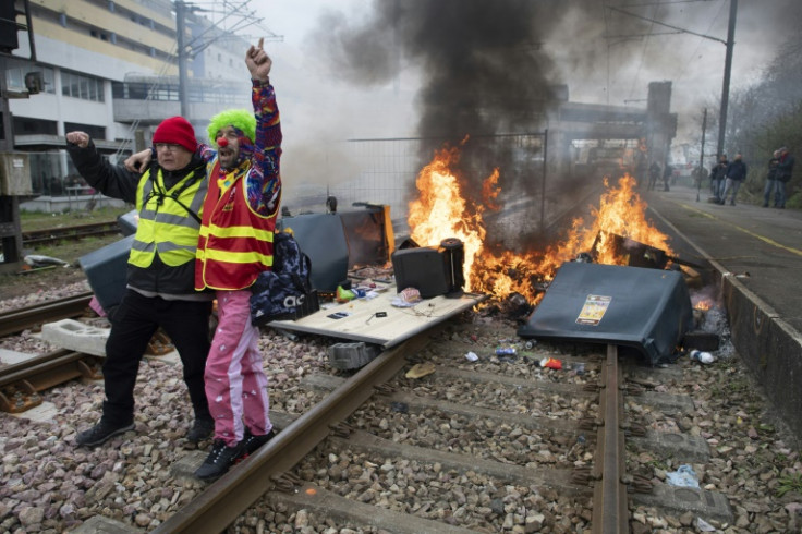 Protesters dressed as clowns block a railway line at Lorient in western France Tuesday