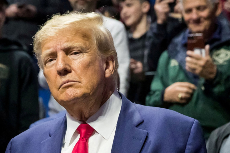 Former President Donald Trump greets fans as he arrives at NCAA Wrestling Championships