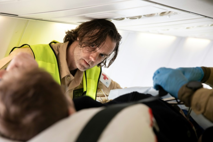 A Ukrainian medic checks on a wounded soldier on board the flying hospital