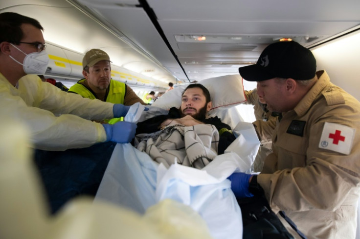 Wounded Ukrainian soldier Vladyslav Shakhov is preparing to be moved upon arrival in Berlin in a medevac flight