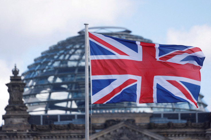 Flags fly in front of the Reichstag building