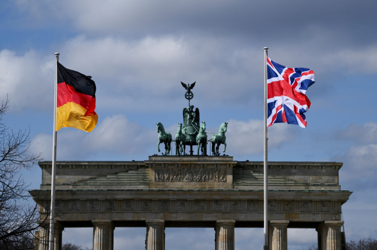 A German and a Union Jack flag fly at Brandenburg Gate, in Berlin