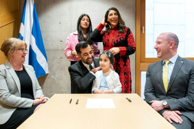 Humza Yousaf with his family and political allies after signing the nomination form to become first minister of Scotland
