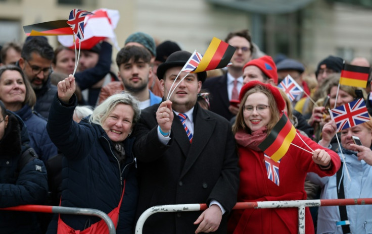 Spectators lined up along the sides of the square in front of the Brandenburg Gate waved German and British flags ahead of the royals' arrival