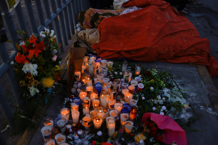 Migrants sleep next to an altar outside the migrant detention center where several migrants died after a fire broke out late on Monday, in Ciudad Juarez