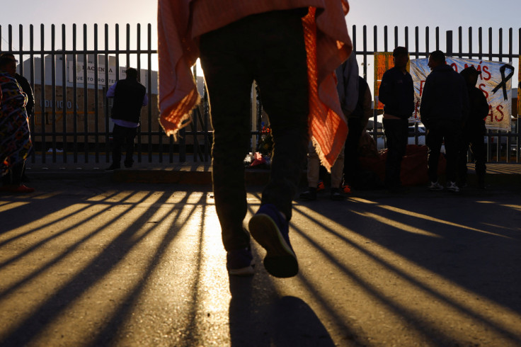 A migrant walks in front of an altar outside the migrant detention center where several migrants died after a fire broke out late on Monday, in Ciudad Juarez