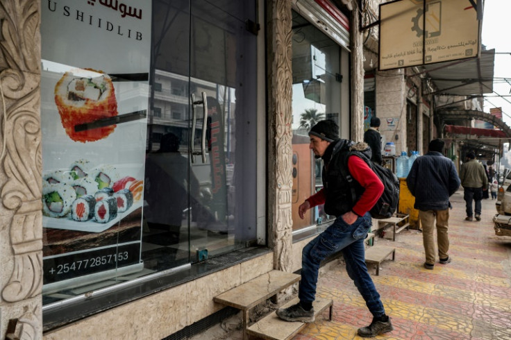 Islam Shakhbanov arrives at his sushi restaurant in Syria's rebel-held northwestern city of Idlib