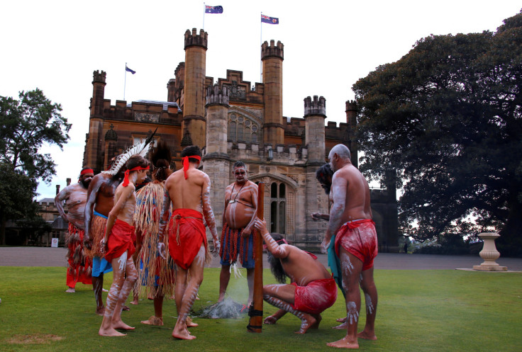 Australian Aborigines and Torres Strait Islanders wearing traditional dress stand in front of Government House after performing in a welcoming ceremony in Sydney