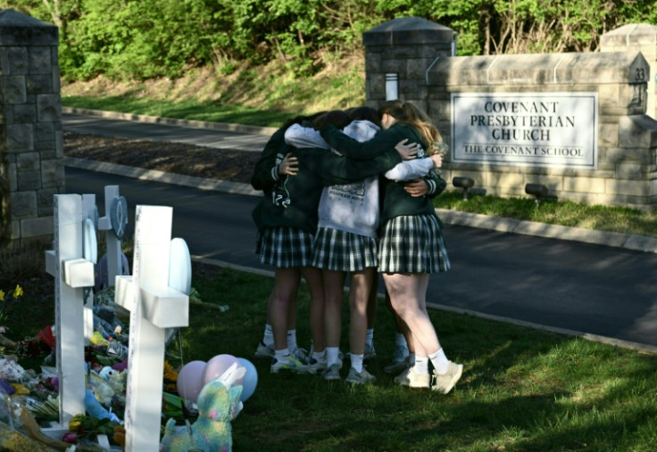 School girls comforted each other after laying flowers at the makeshift memorial for the victims of a shooting at The Covenant School in Nashville, Tennessee