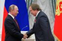Russian President Putin shakes hands with artistic director of St. Petersburg House of Music Sergei Roldugin in Moscow