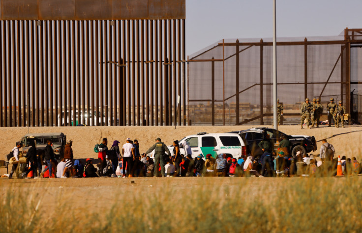 Migrants are detained by U.S. Border Patrol agents after crossing the Rio Bravo river as seen from Ciudad Juarez