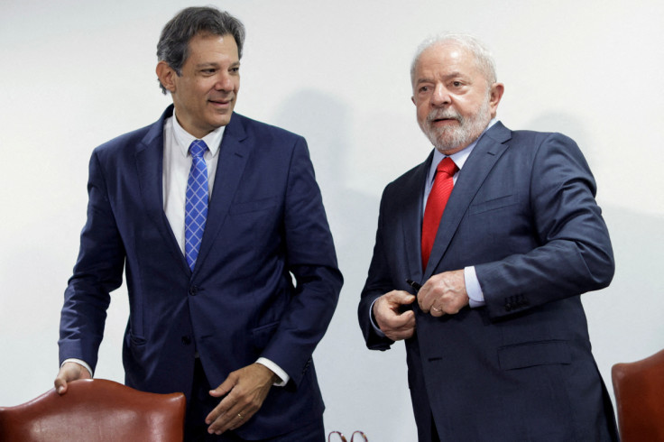 Brazil's Economy Minister Fernando Haddad greets President Luiz Inacio Lula da Silva during a meeting to sign the government's economic package at the Planalto Palace in Brasilia