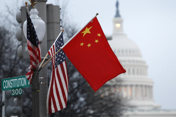 The People's Republic of China flag and the U.S. Stars and Stripes fly on a lamp post along Pennsylvania Avenue near the U.S. Capitol in Washington