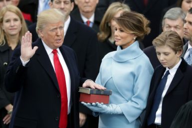 Former US president Donald Trump is pictured in January 2017 taking the oath of office next to his wife Melania and son Barron