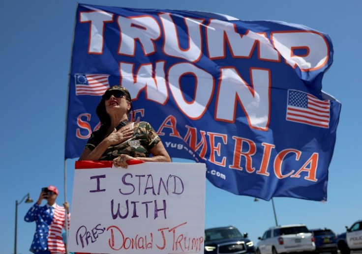 Trump fans like Cindy Falco-DiCarrado, pictured near his Florida home on March 21, 2023, have remained loyal amid the former US president's many scandals