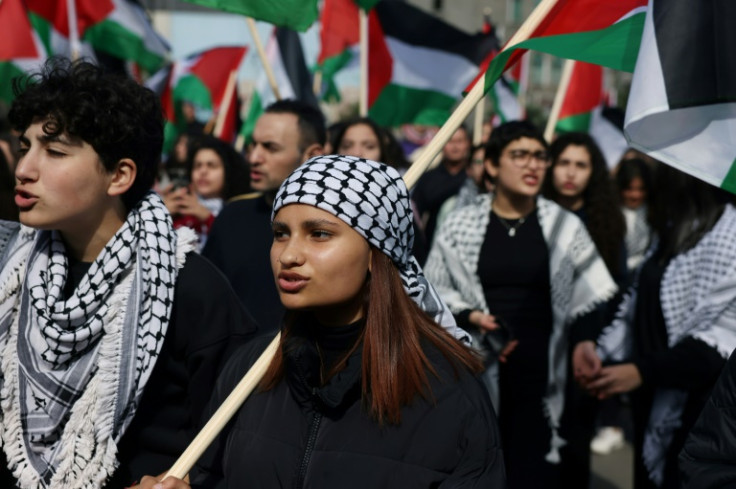 Protesters in Sakhnin wave Palestinian flags and wear the traditional keffiyeh scarf during a march on the 47th Land Day