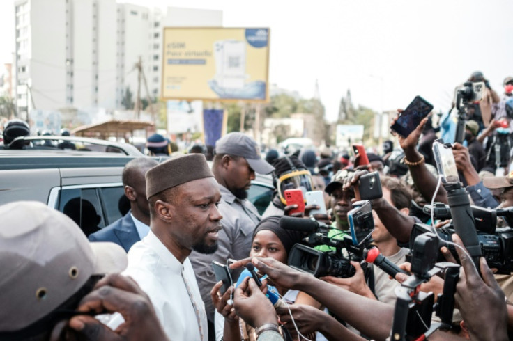 Opposition leader  Ousmane Sonko speaks to reporters in Dakar on the way to court on March 16
