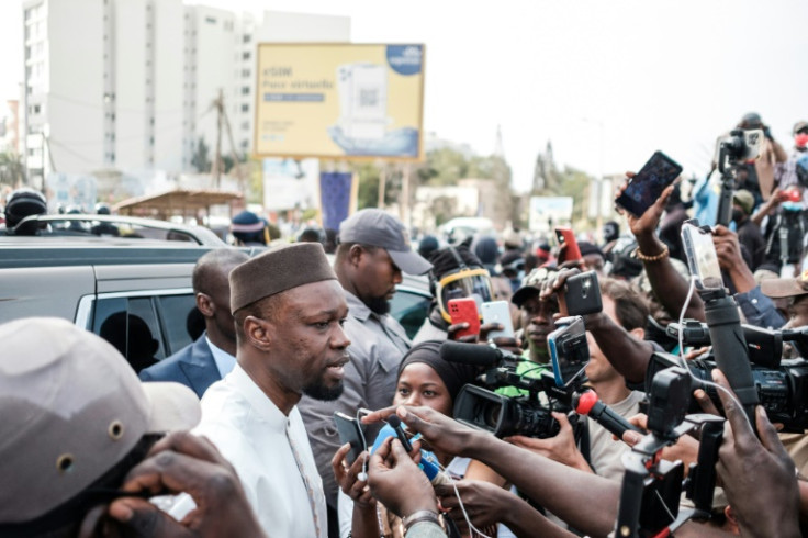 Opposition leader Ousmane Sonko speaks to reporters in Dakar on the way to court on March 16