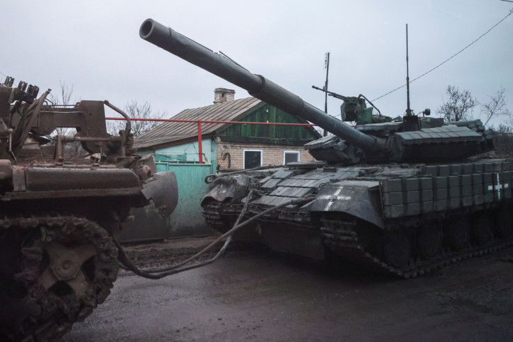 A tank is towed through a road near Bakhmut