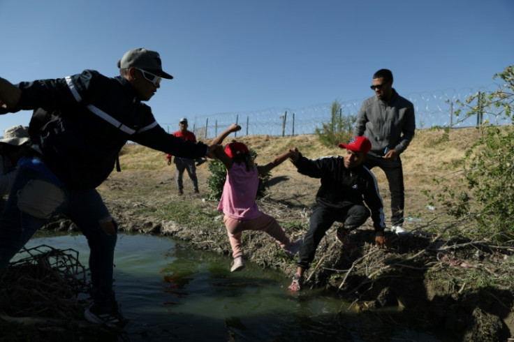 Migrants near Ciudad Juarez cross the Rio Grande that separates Mexico from the United States