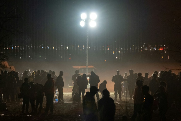 Migrants wait to be processed by the US Border Patrol, seen from the Mexican side of the US-Mexico border in Ciudad Juarez