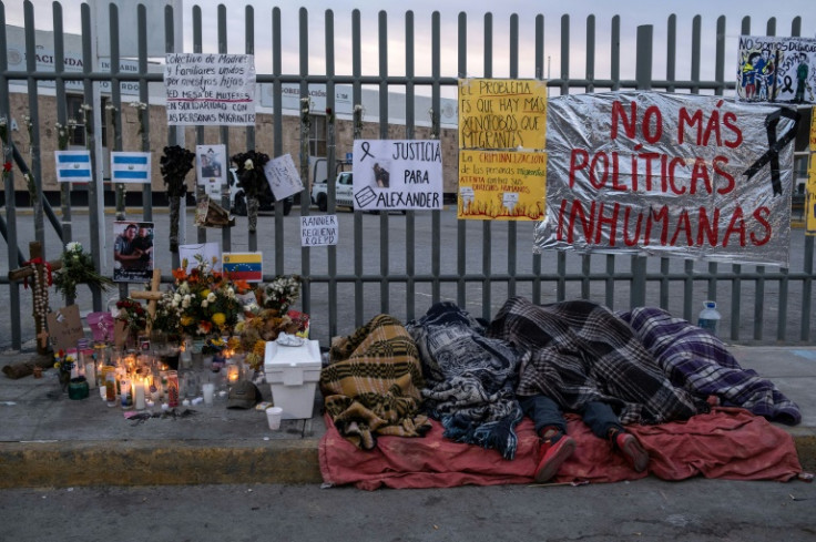 Migrants sleep outside the detention center in Ciudad Juarez, Mexico, where 39 migrants died during a fire