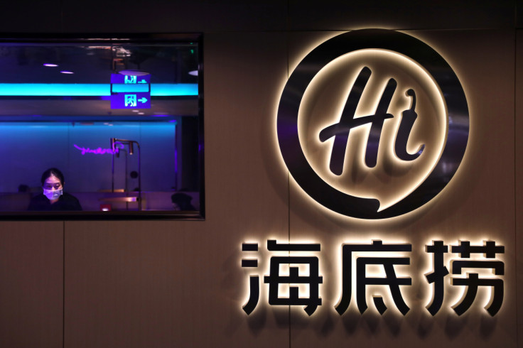 Staff member attends customers at a Haidilao hotpot restaurant in Beijing