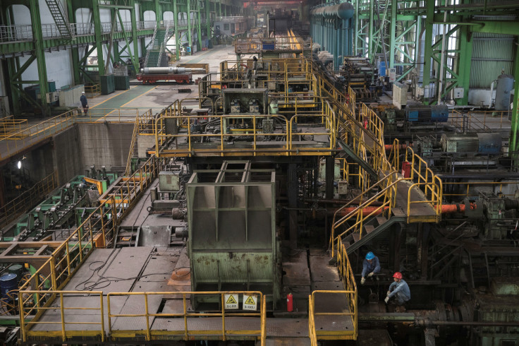Workers are seen at a hot rolling production line at the Chongqing Iron and Steel plant in Changshou