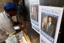 Newspaper vendor sets up his stall outside court ahead of South African "Blade Runner" Oscar Pistorius' court appearance in Pretoria
