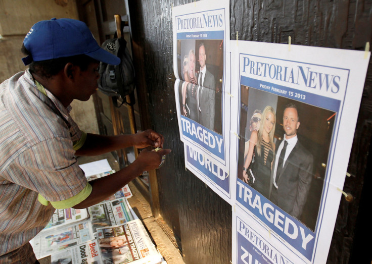 Newspaper vendor sets up his stall outside court ahead of South African "Blade Runner" Oscar Pistorius' court appearance in Pretoria