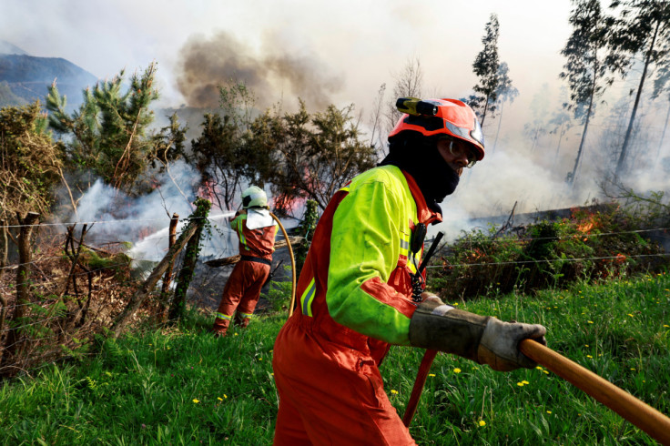 Firefighters use a controlled burn to tackle a wildfire in Setienes