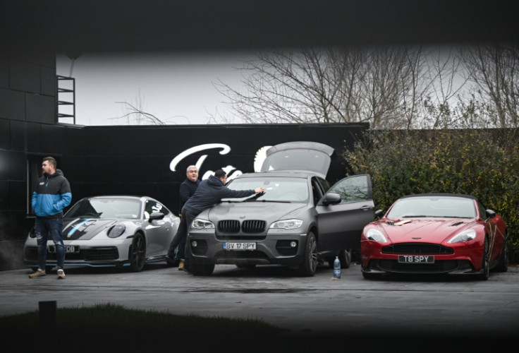 Luxury cars are pictured at "The Hustlers University" site belonging to Andrew Tate and his brother